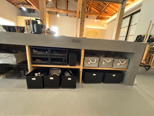 a loft bed with boxes of shoes in a room at My Place 小豆島 1日1組限定 海近の贅沢ステイ 2025年フルリノベ 洗練モダンデザイン 最大8名 一棟貸切 in Tonosho