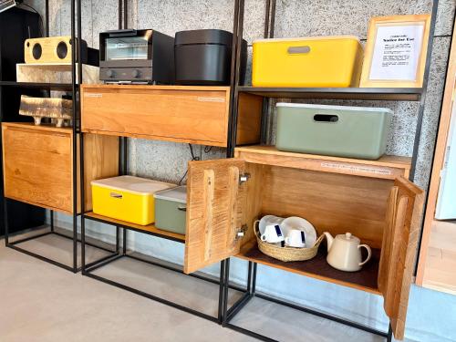 a shelf filled with lots of different types of furniture at My Place 小豆島 1日1組限定 海近の贅沢ステイ 2025年フルリノベ 洗練モダンデザイン 最大8名 一棟貸切 in Tonosho