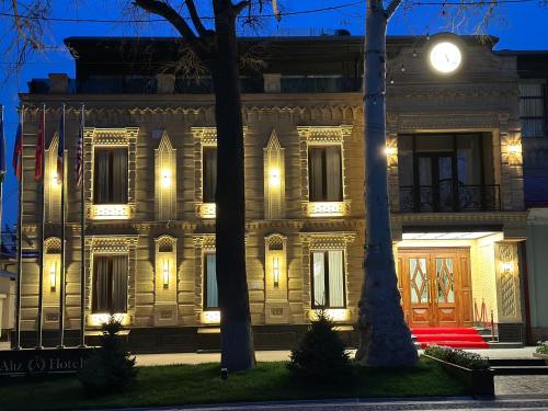 a building with lights in front of it at night at Aliz Boulevard Hotel in Samarkand