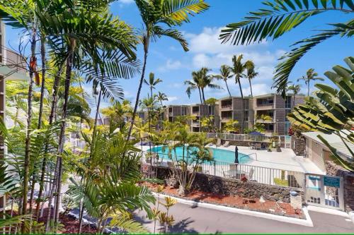an aerial view of a resort with a pool and palm trees at Cozy 1 Bdrm Condo at Ali'i Villas in Kailua-Kona