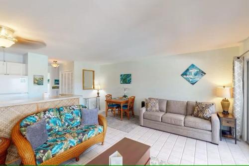 a living room with a couch and a table at Cozy 1 Bdrm Condo at Ali'i Villas in Kailua-Kona