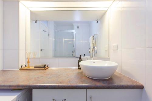 a bathroom with a white bowl sink on a counter at Fremantle Sunset Studio Rottnest Island Views in Fremantle