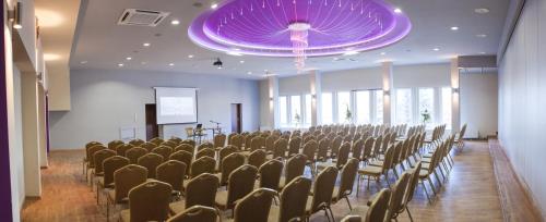 a large room with chairs and a purple ceiling at Hotel Przedwiośnie in Masłów