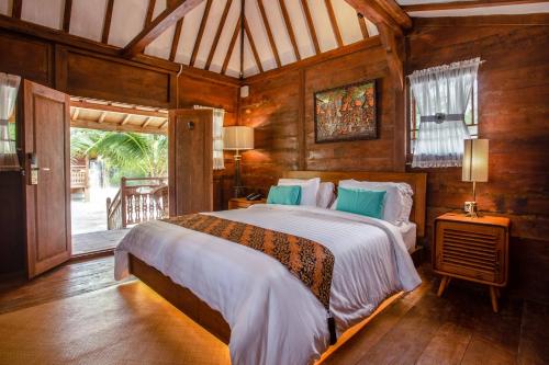 a bedroom with a large bed in a room at Bintan Exotica Resort By WH - Free Shuttle BBT Resort BBT - Free Breakfast in Berakit