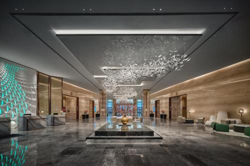 a lobby with a fountain in the middle of a building at Crowne Plaza Wuhan Tianhe Airport by IHG in Wuhan