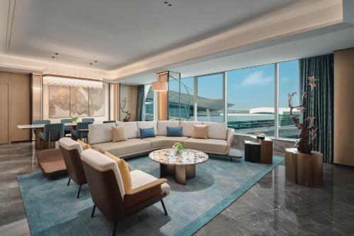 a living room with a couch and a table at Crowne Plaza Wuhan Tianhe Airport by IHG in Wuhan