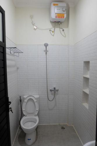 a bathroom with a shower and a toilet at Cozy Dwelling in Ngaglik