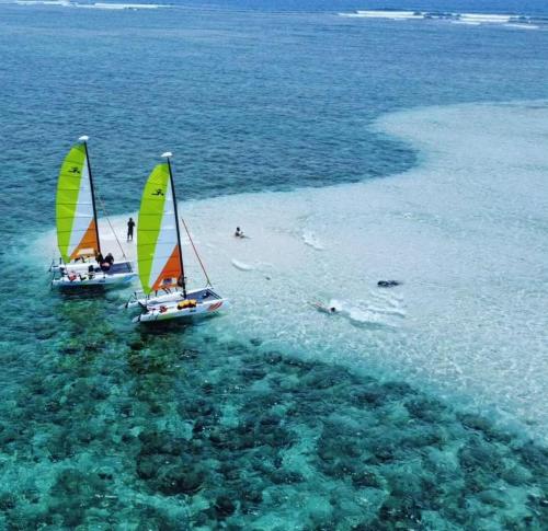 two boats with sails in the water on a beach at Olum Beach Loft in Antón Lizardo