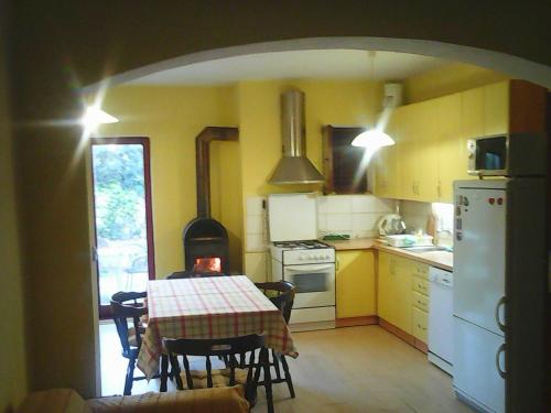 a kitchen with a table and a kitchen with a stove at Apartment Len Slovaci in Zadar