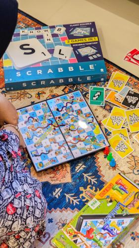 a table topped with lots of games and boxes at Casa Candali, Farm Haven - Bogor Short Getaway - Respectful Guest Only in Bogor