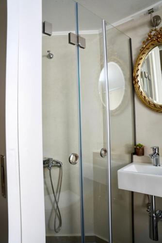 a bathroom with a shower and a sink at Apiro Syros in Ermoupoli