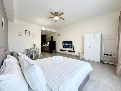 a bedroom with a bed and a ceiling fan at Sunsuria Forum SOHO & Residence Suites Setia Alam by MOKA in Shah Alam