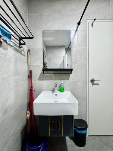 a bathroom with a white sink and a mirror at Sunsuria Forum SOHO & Residence Suites Setia Alam by MOKA in Shah Alam
