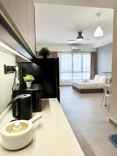 a bathroom with a toilet in a room with a bed at Sunsuria Forum SOHO & Residence Suites Setia Alam by MOKA in Shah Alam