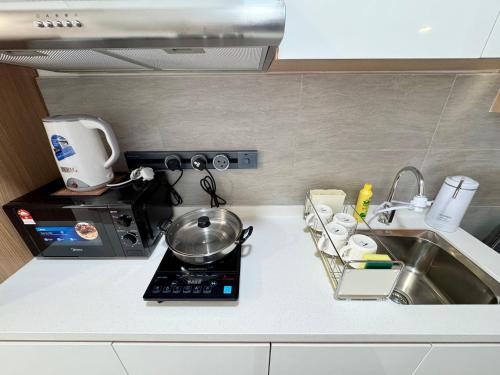 a kitchen counter with a sink and a mixer at Sunsuria Forum SOHO & Residence Suites Setia Alam by MOKA in Shah Alam