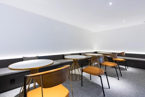 a row of tables and chairs in a room at LZ Hotel in Chengdu