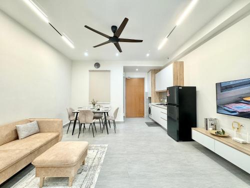 a living room with a couch and a ceiling fan at Sunsuria Forum SOHO & Residence Suites Setia Alam by MOKA in Shah Alam