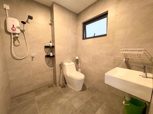 a bathroom with a toilet and a sink and a shower at Sunsuria Forum SOHO & Residence Suites Setia Alam by MOKA in Shah Alam