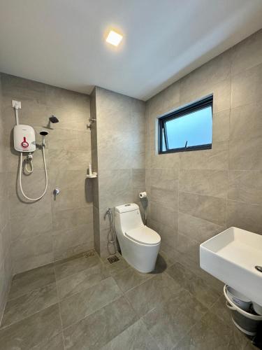 a bathroom with a toilet and a sink and a window at Sunsuria Forum SOHO & Residence Suites Setia Alam by MOKA in Shah Alam
