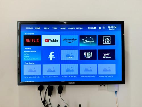 a flat screen tv hanging on a wall at Sunsuria Forum SOHO & Residence Suites Setia Alam by MOKA in Shah Alam