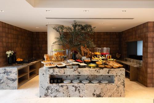 a buffet of food on a table in a room at ZANA by the Ganges, Tapovan, Rishikesh in Rishīkesh