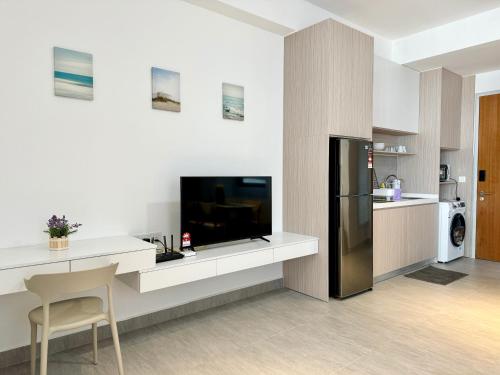 a kitchen with a tv and a counter with a refrigerator at Sunsuria Forum SOHO & Residence Suites Setia Alam by MOKA in Shah Alam
