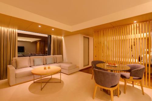a living room with a couch and a table at Keys Prima by Lemon Tree Hotels, Kota, Rajasthan in Kota