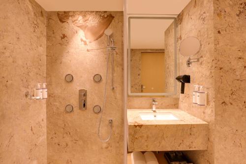 a bathroom with a shower and a sink at Keys Prima by Lemon Tree Hotels, Kota, Rajasthan in Kota