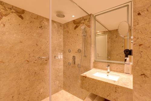 a bathroom with a sink and a shower at Keys Prima by Lemon Tree Hotels, Kota, Rajasthan in Kota