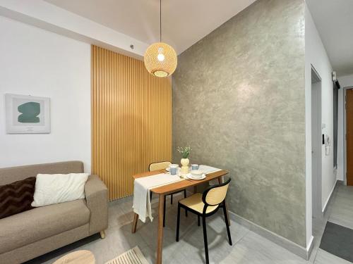 a living room with a table and a couch at Sunsuria Forum SOHO & Residence Suites Setia Alam by MOKA in Shah Alam