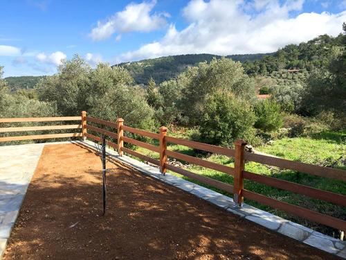 a wooden fence with a view of a mountain at Aria Monte Villas in Raches