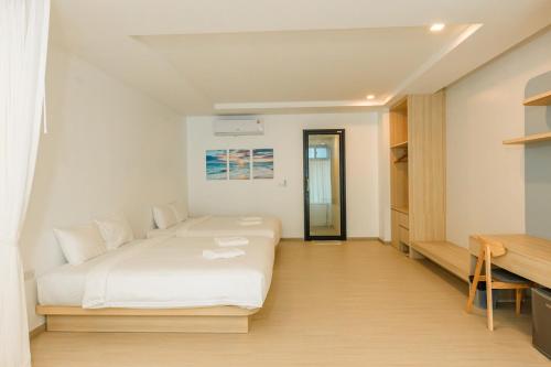 a bedroom with a white bed and a desk at Sea Side at Ao Nang Landmark Night Market Krabi in Ban Khlong Haeng