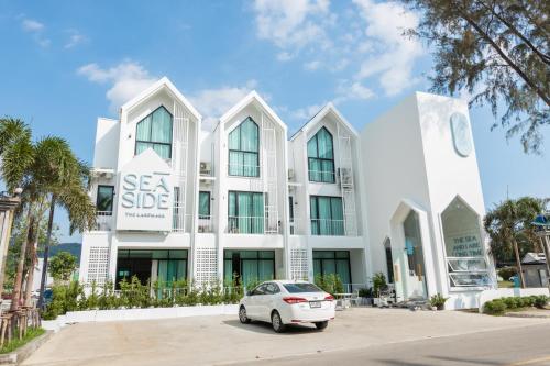 a car parked in front of a white building at Sea Side at Ao Nang Landmark Night Market Krabi in Ban Khlong Haeng