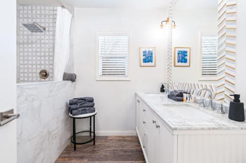a white bathroom with a sink and a shower at Maison on the Beach in Los Angeles