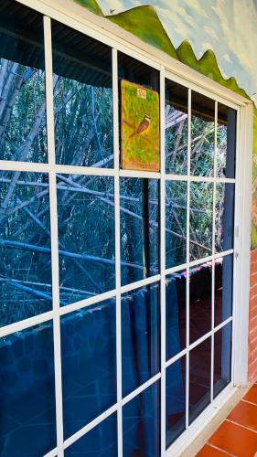 a window in a room with a wall of glass at Hostal El Mirador in Minca