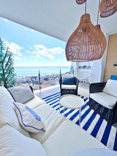 a living room with a couch and a view of the ocean at Sea view apartments with Year-Round Open Pool in Manilva