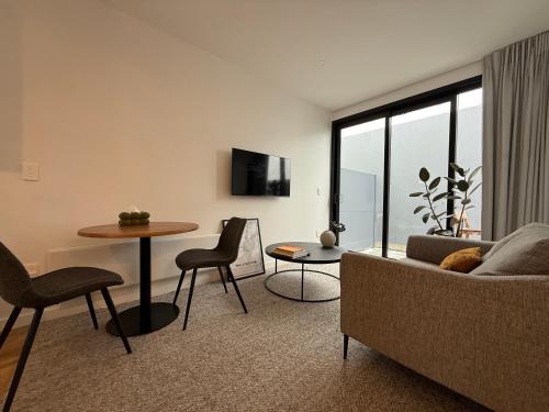 a living room with a couch and a table at Stylish 2 bedrooms townhouse in central Wellington with a free car park in Wellington