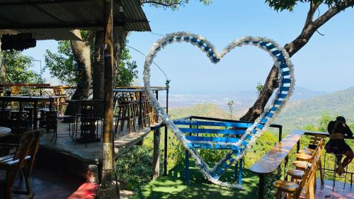 a blue bench with a heart painted on it at Hostal El Mirador in Minca