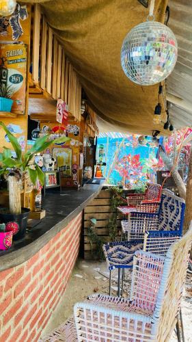 a restaurant with chairs and a table at Hostal El Mirador in Minca