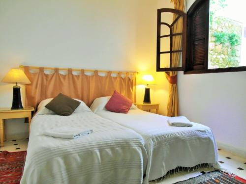 a bedroom with a bed with two pillows on it at Christina's House in Asilah