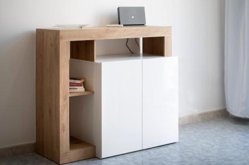 a wooden desk with a laptop on top of it at Casa Giorgia in Mesagne