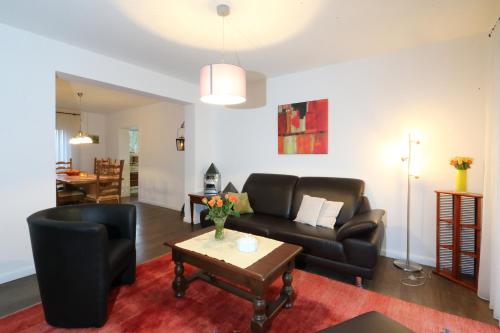 a living room with a couch and a table at Ferienwohnungen Grafenfelder Hof in Gerolstein
