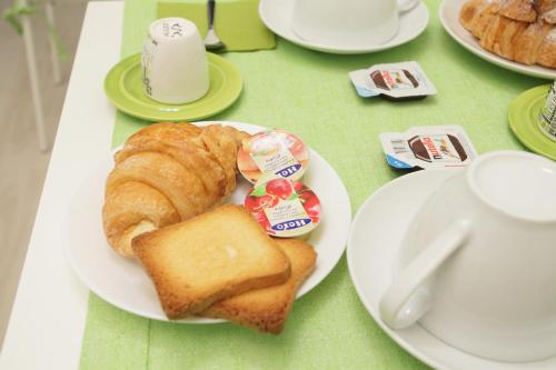 a white plate with bread and toast on a table at B&B San Domenico in Modugno