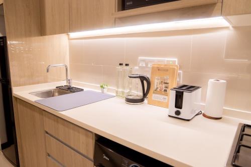 a kitchen with a sink and a coffee maker on a counter at Urban Oasis, Tri-Zen Luxury Apartment in Central Colombo in Colombo