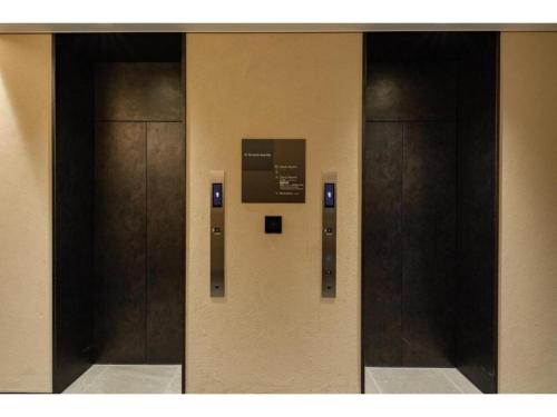 a row of elevator doors in a building at The OneFive Kyoto Shijo - Vacation STAY 41806v in Kyoto