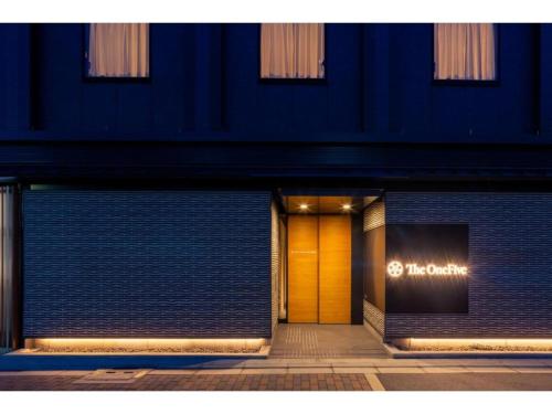a front door of a building with a yellow door at The OneFive Kyoto Shijo - Vacation STAY 41806v in Kyoto