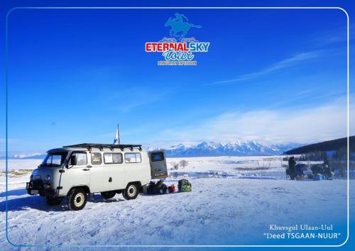 a white jeep parked in the snow at Eternal Sky Tour & Guest house in Ulaanbaatar