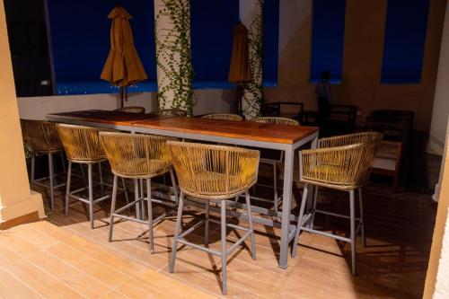 a bar with rattan chairs around it in a room at Urban Oasis, Tri-Zen Luxury Apartment in Central Colombo in Colombo