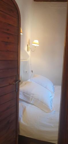 a bedroom with a bed with a light on the wall at CasaFraBorgo in Sacrofano