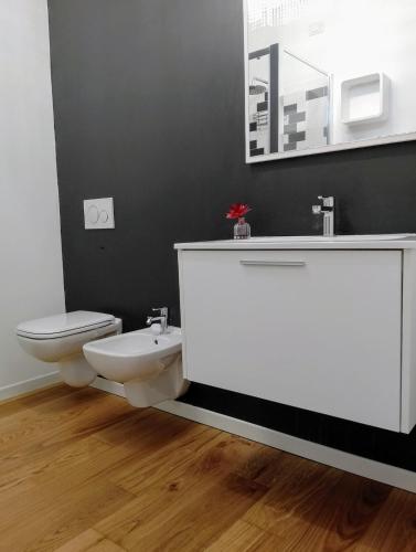 a bathroom with a white sink and a toilet at La casa al lago in Bosisio Parini